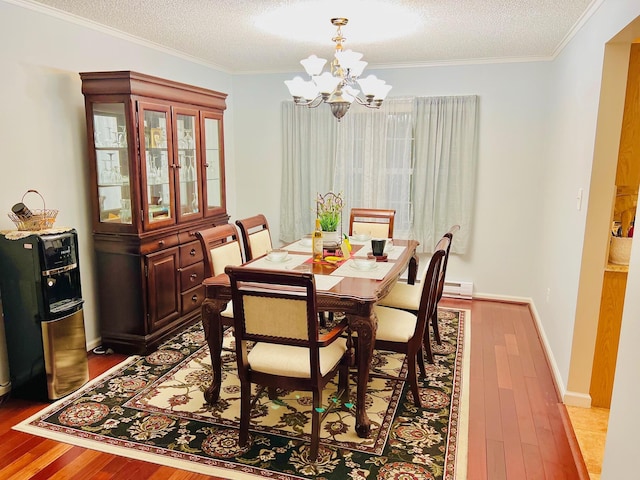 2105 Larkspur Ln, Tobyhanna, PA 18466 - dining room featuring a chandelier, hardwood / wood-style flooring, crown molding, a textured ceiling, and baseboards