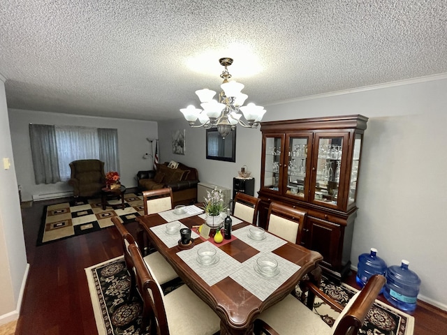 dining space with baseboards, wood finished floors, a textured ceiling, a baseboard heating unit, and a notable chandelier