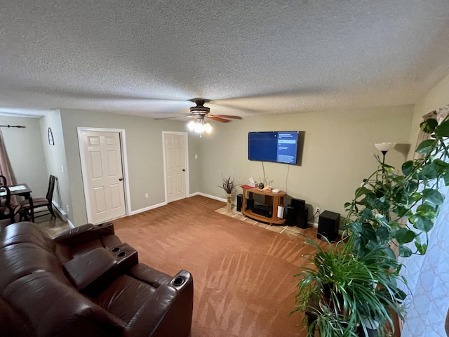 carpeted living area featuring a textured ceiling, a ceiling fan, and baseboards