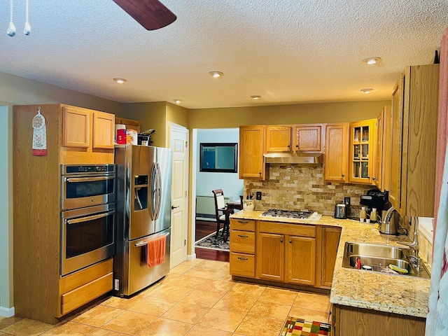 2105 Larkspur Ln, Tobyhanna, PA 18466 - kitchen with stainless steel appliances, a sink, decorative backsplash, glass insert cabinets, and under cabinet range hood