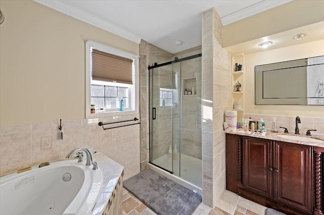 bathroom with vanity, tile walls, a tub with jets, a stall shower, and crown molding