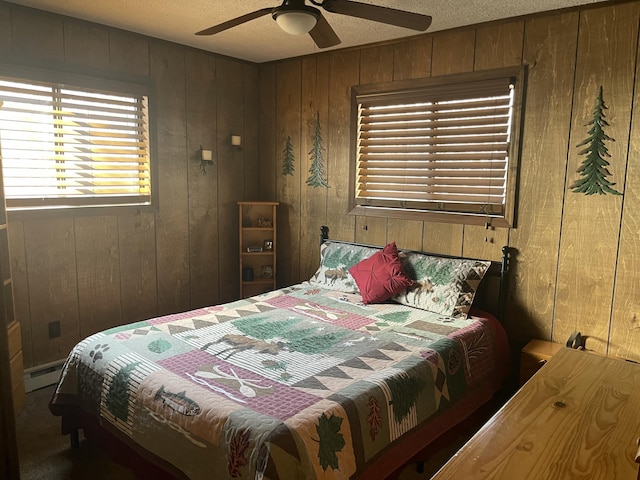 172 Larsen Dr, Clifton Township, PA 18424 - bedroom with carpet flooring, a textured ceiling, a ceiling fan, wood walls, and a baseboard radiator