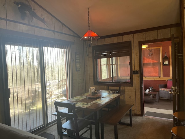 172 Larsen Dr, Clifton Township, PA 18424 - dining room featuring carpet, vaulted ceiling, wooden walls, and a wealth of natural light