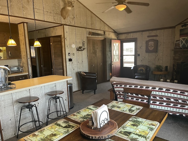 172 Larsen Dr, Clifton Township, PA 18424 - dining space with vaulted ceiling, wood walls, a toaster, and a ceiling fan