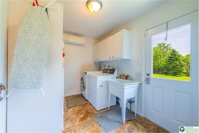 5622 Snowdrift Rd, Orefield, PA 18069 - laundry room featuring washing machine and dryer, a wall mounted AC, cabinet space, and light stone finish floors