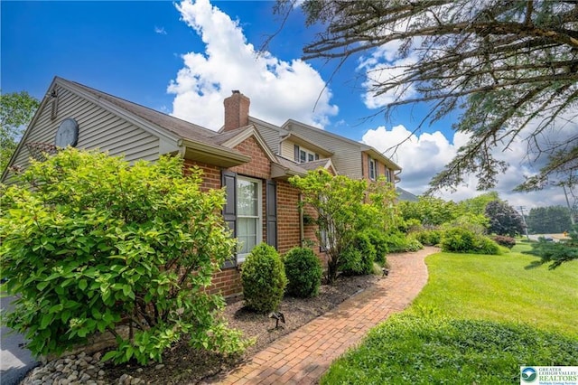 5622 Snowdrift Rd, Orefield, PA 18069 - view of side of property with brick siding, a chimney, and a yard
