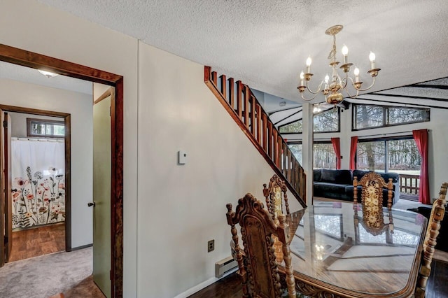 carpeted dining room with a baseboard radiator, a textured ceiling, a chandelier, and vaulted ceiling