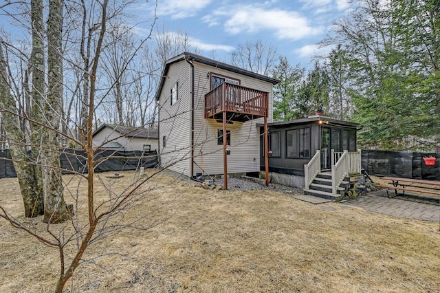 exterior space with fence and a sunroom