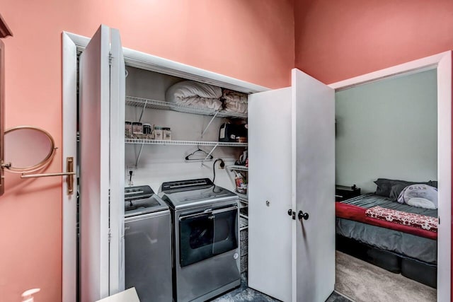 washroom featuring carpet, laundry area, and washing machine and dryer