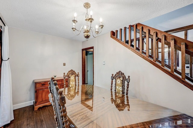 dining area with dark wood finished floors, stairway, a notable chandelier, and a textured ceiling