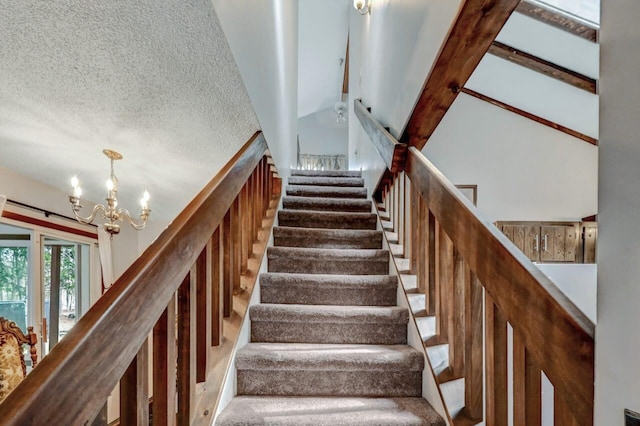 stairway with a textured ceiling and a chandelier