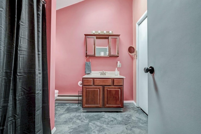 full bathroom with baseboards, toilet, baseboard heating, and vanity