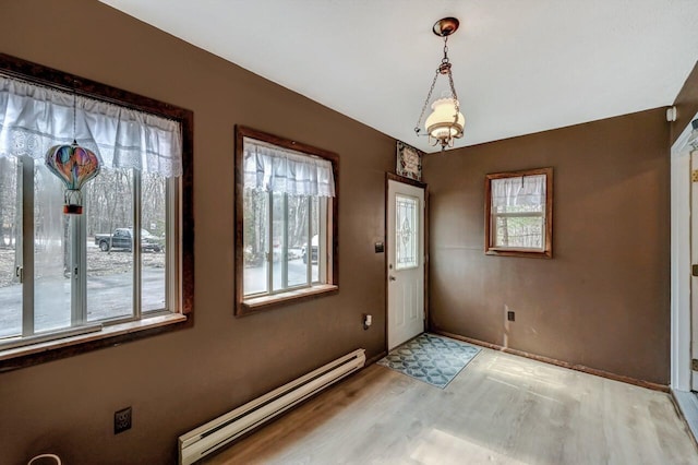 entrance foyer featuring light wood-type flooring, baseboards, and baseboard heating