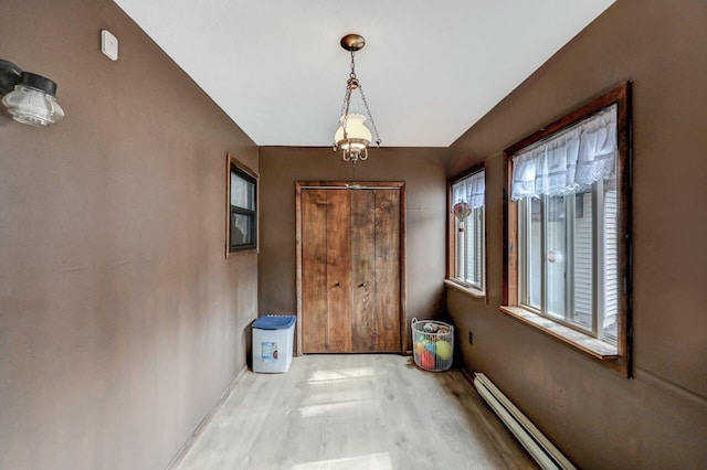 entryway featuring wood finished floors and baseboard heating