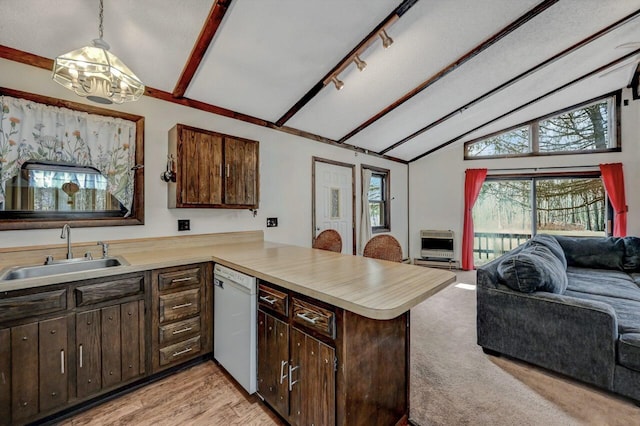 kitchen with a notable chandelier, a sink, open floor plan, white dishwasher, and light countertops