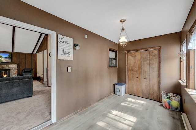 dining space featuring wood finished floors and a fireplace