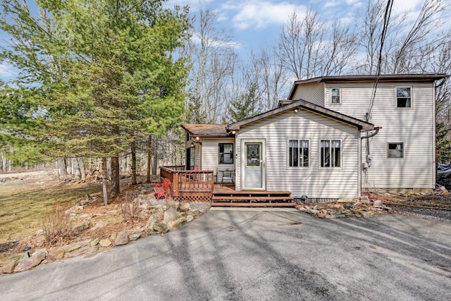 rear view of property featuring a deck