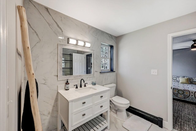 348 Mountain Top Lake Rd, Long Pond, PA 18334 - full bathroom featuring toilet, ensuite bath, vanity, tile walls, and a ceiling fan
