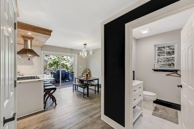 348 Mountain Top Lake Rd, Long Pond, PA 18334 - hallway featuring a chandelier, light wood-style floors, and baseboards