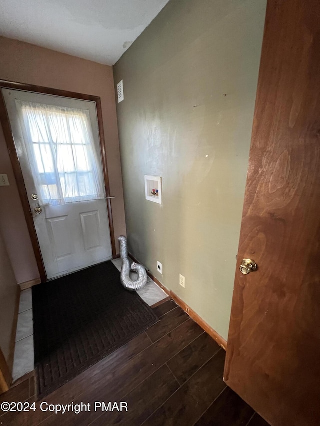 doorway to outside featuring visible vents, baseboards, and wood finished floors