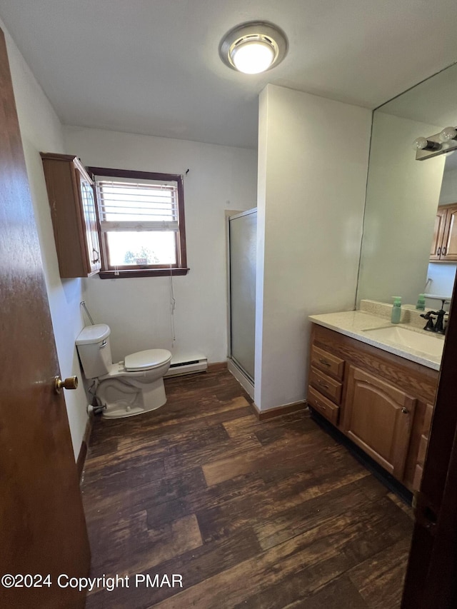 full bathroom featuring a baseboard radiator, toilet, vanity, a shower stall, and wood finished floors