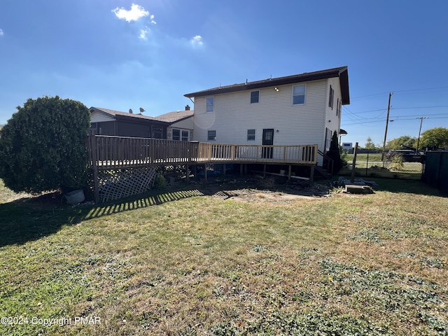 back of house with a yard, fence, and a deck