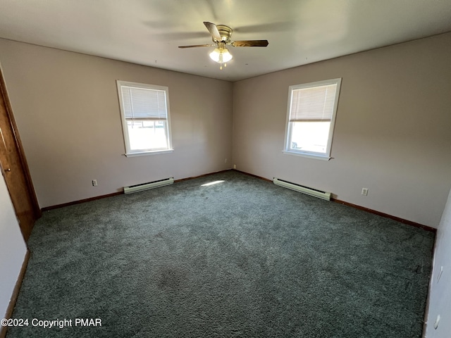 carpeted spare room with a wealth of natural light, ceiling fan, and baseboard heating