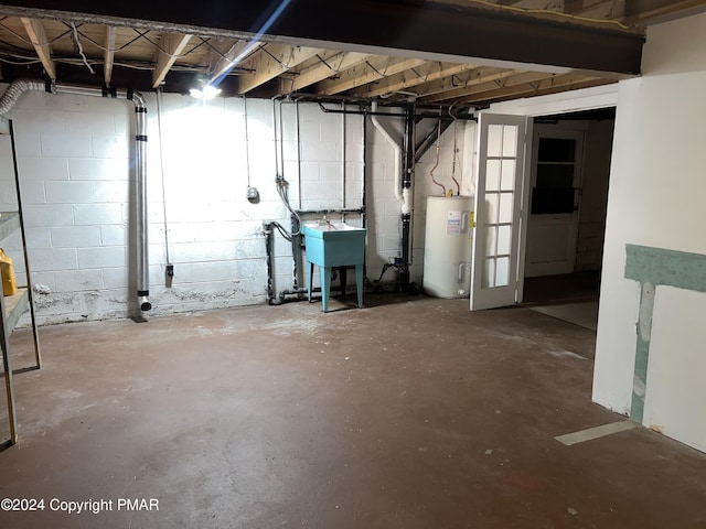 unfinished basement with water heater and a sink