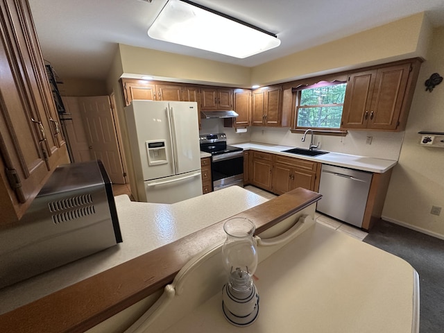 110 Alwen Ave, East Stroudsburg, PA 18301 - kitchen with stainless steel appliances, under cabinet range hood, light countertops, light colored carpet, and brown cabinets