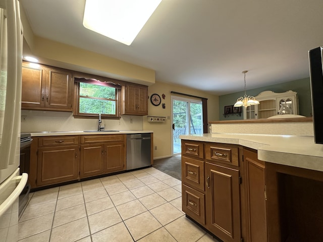 110 Alwen Ave, East Stroudsburg, PA 18301 - kitchen featuring stainless steel appliances, light countertops, a chandelier, light tile patterned floors, and hanging light fixtures