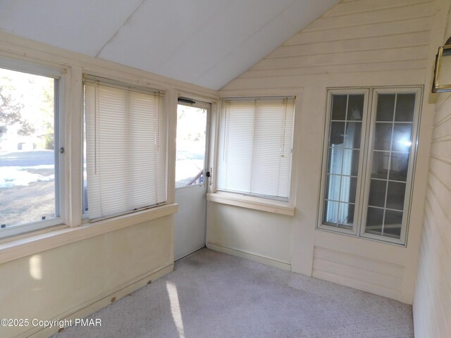 unfurnished sunroom featuring vaulted ceiling