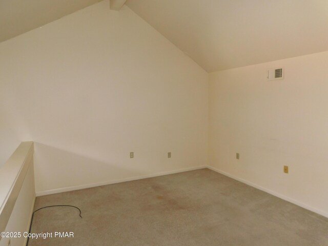 carpeted empty room with lofted ceiling with beams, visible vents, and baseboards