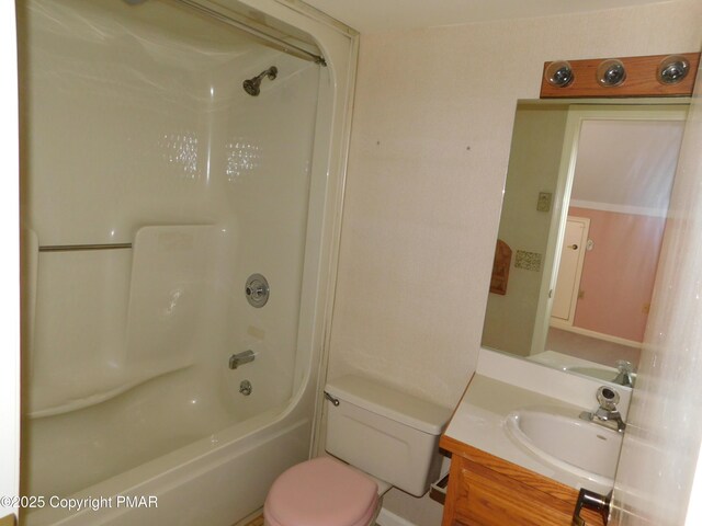 bathroom featuring toilet, bathing tub / shower combination, and vanity