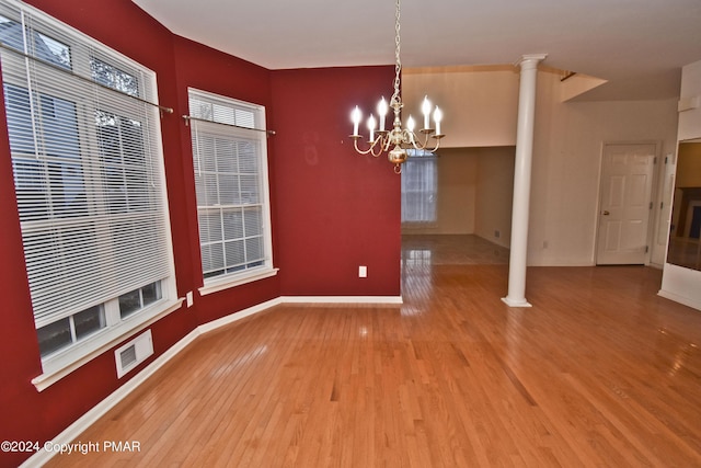 127 Bethpage Ter, Easton, PA 18042 - unfurnished dining area featuring decorative columns, wood finished floors, and a chandelier