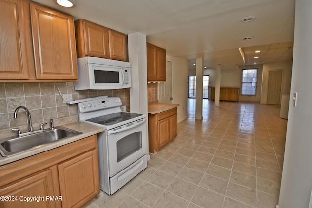 127 Bethpage Ter, Easton, PA 18042 - kitchen featuring white appliances, light tile patterned floors, backsplash, light countertops, and recessed lighting