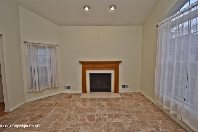 127 Bethpage Ter, Easton, PA 18042 - unfurnished living room featuring a fireplace with flush hearth, vaulted ceiling, recessed lighting, and stone finish floors