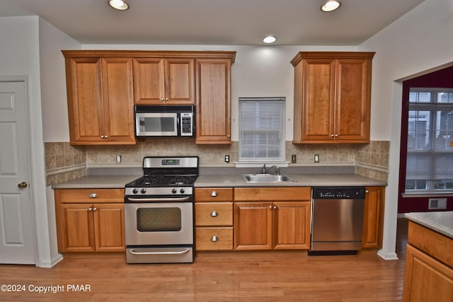 127 Bethpage Ter, Easton, PA 18042 - kitchen featuring appliances with stainless steel finishes, brown cabinetry, light wood-style flooring, and recessed lighting