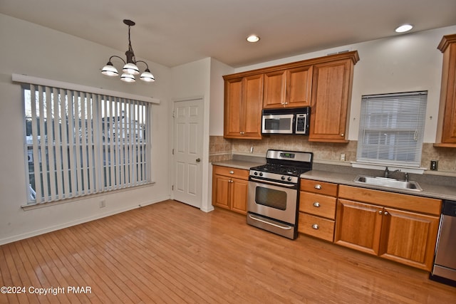 127 Bethpage Ter, Easton, PA 18042 - kitchen featuring stainless steel appliances, a chandelier, backsplash, brown cabinetry, and recessed lighting
