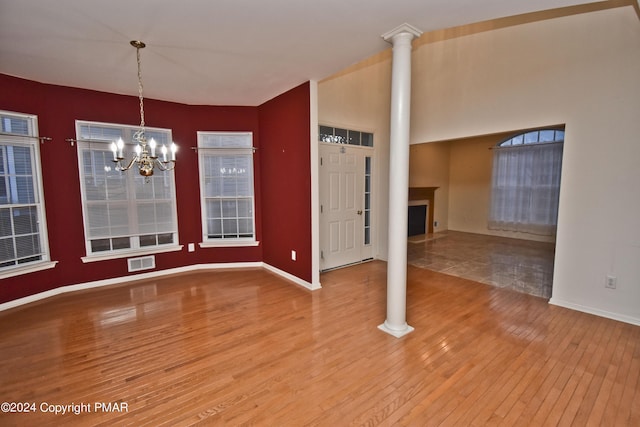 127 Bethpage Ter, Easton, PA 18042 - interior space featuring wood-type flooring, a chandelier, a fireplace, and ornate columns