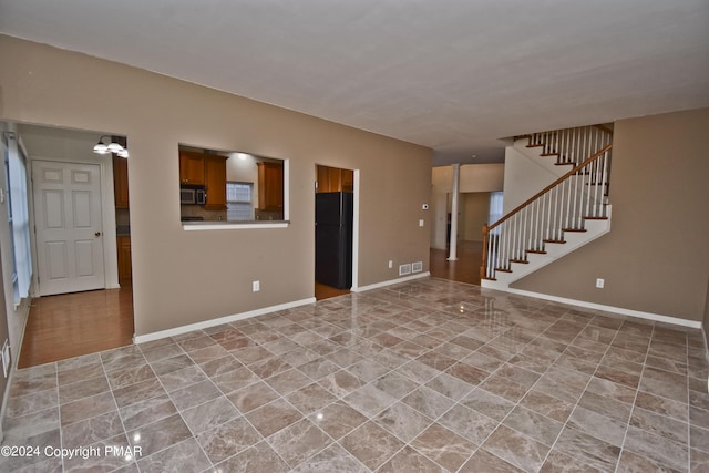 127 Bethpage Ter, Easton, PA 18042 - unfurnished living room with stairway and a chandelier