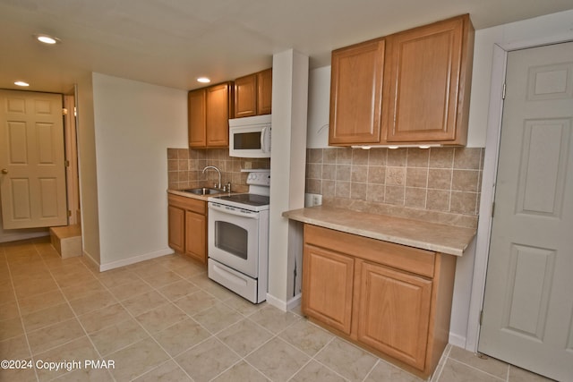 127 Bethpage Ter, Easton, PA 18042 - kitchen featuring white appliances, light tile patterned flooring, light countertops, recessed lighting, and backsplash