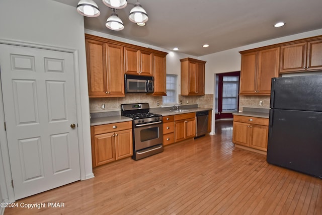 127 Bethpage Ter, Easton, PA 18042 - kitchen featuring stainless steel appliances, light wood-style flooring, brown cabinets, backsplash, and recessed lighting