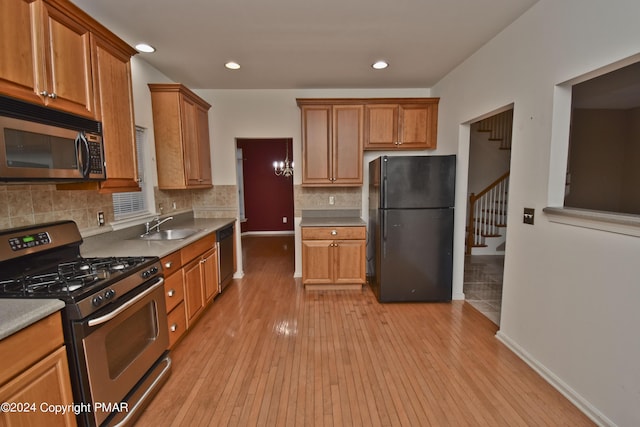 127 Bethpage Ter, Easton, PA 18042 - kitchen with appliances with stainless steel finishes, light wood finished floors, backsplash, brown cabinetry, and recessed lighting
