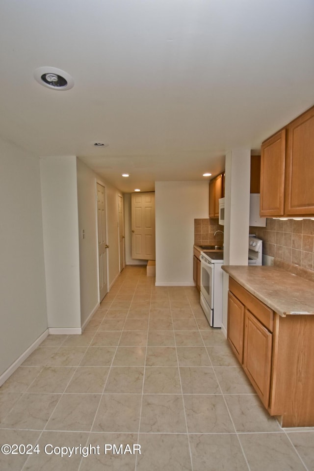 127 Bethpage Ter, Easton, PA 18042 - kitchen with decorative backsplash, light tile patterned floors, recessed lighting, electric range, and light countertops