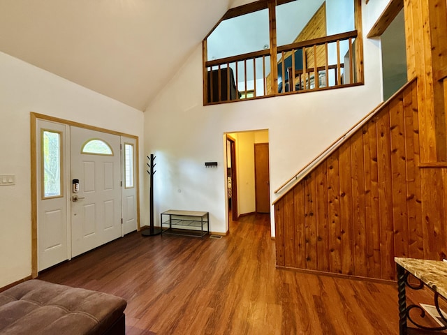 119 Sterling Cir, Bushkill, PA 18324 - foyer with high vaulted ceiling, wood finished floors, stairway, and wooden walls