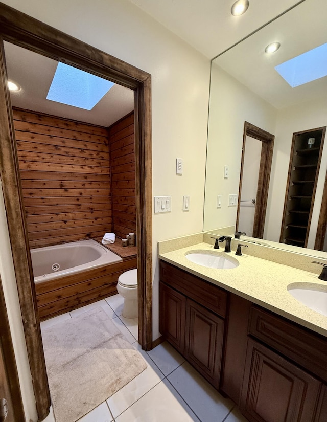 119 Sterling Cir, Bushkill, PA 18324 - bathroom with a skylight, a jetted tub, double vanity, tile patterned floors, and recessed lighting