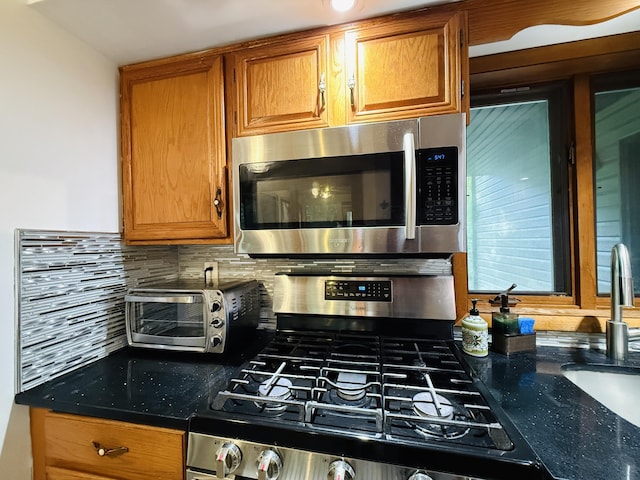 119 Sterling Cir, Bushkill, PA 18324 - kitchen featuring stainless steel appliances, decorative backsplash, brown cabinets, and dark stone countertops