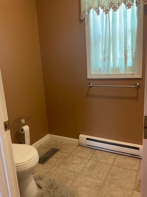 3124 Bluebird Dr, Bushkill, PA 18324 - bathroom with a baseboard heating unit and tile patterned floors