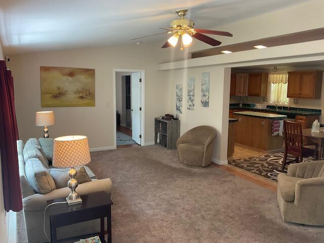3124 Bluebird Dr, Bushkill, PA 18324 - living area featuring ceiling fan, vaulted ceiling, and light colored carpet