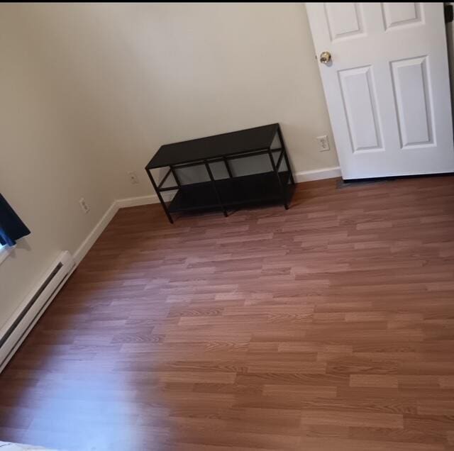 3124 Bluebird Dr, Bushkill, PA 18324 - empty room featuring baseboard heating and wood finished floors